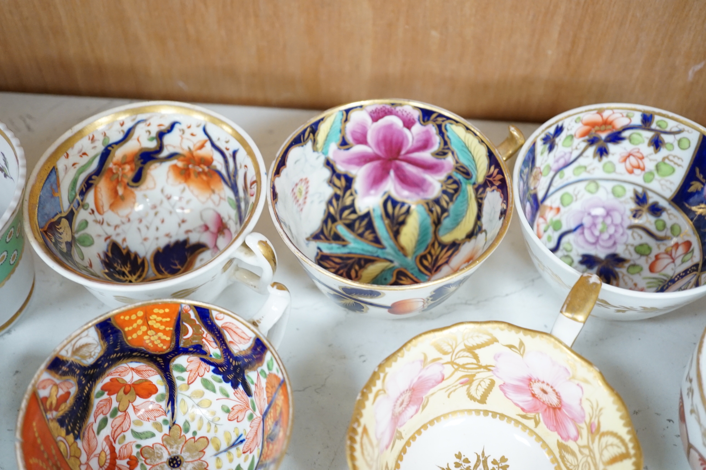 A group of Regency and Victorian porcelain tea, coffee cups and saucers, Newhall, Chamberlains, Coalport, etc.